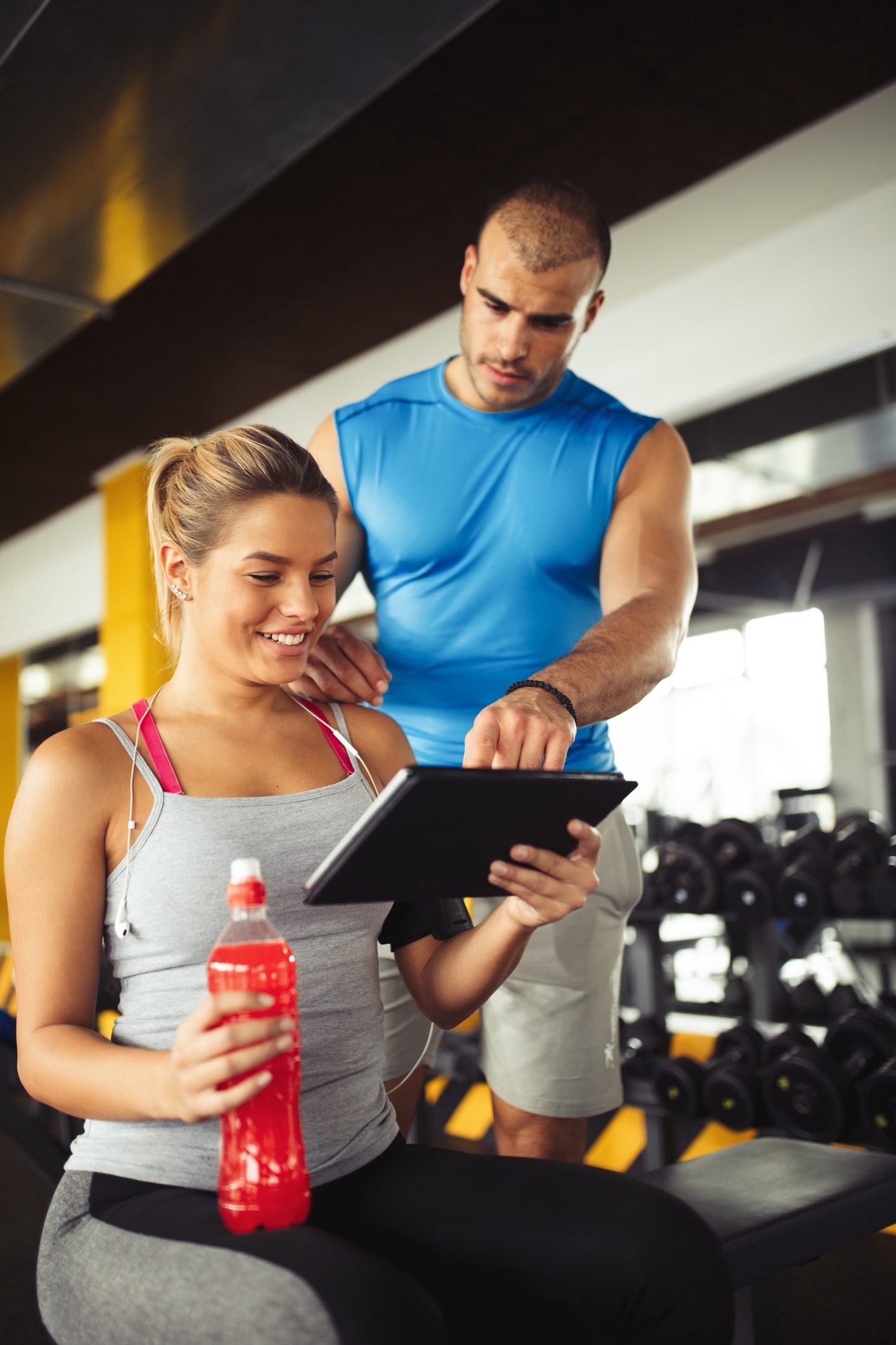 Woman and trainer reviewing workout plan